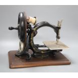 A Victorian Wilcox and Gibb sewing machine and wooden case