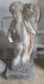 A reconstituted stone garden ornament, putto with a basket of flowers, H.90cm