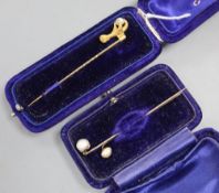 A Victorian yellow metal claw and natural saltwater pearl set stick pin, 68mm and two other