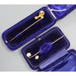 A Victorian yellow metal claw and natural saltwater pearl set stick pin, 68mm and two other