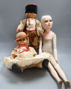 A 1920's boudoir doll, height 68cm and two costume dolls