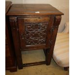 A Tudor style oak cupboard, carved panelled door, on square legs united by stretchers, W.58cm, D.