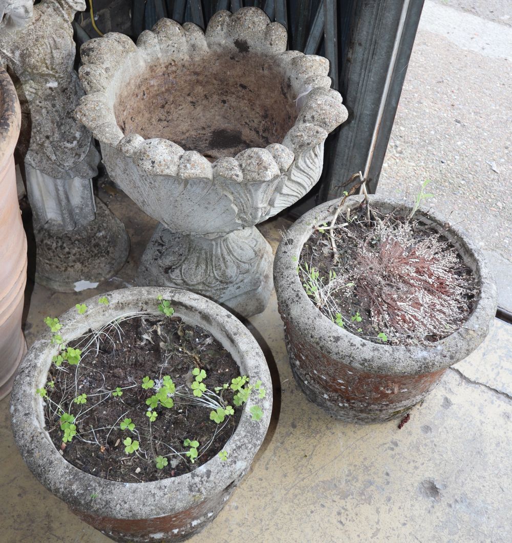 A pair of reconstituted stone garden planters together with a pair of larger campana garden urns,