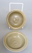 A pair of Chinese celadon 'twin fish' small dishes, diameter 12cm, with associated certificates