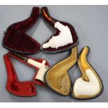 Three Meerschaum pipes, cased