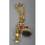 A group of four assorted charms on a yellow metal small chain, including a watch key and carnelian