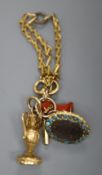 A group of four assorted charms on a yellow metal small chain, including a watch key and carnelian