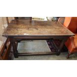 A small late 17th century and later oak refectory table, on gun barrel supports with all round