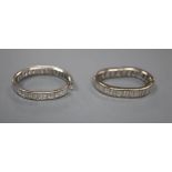 Two white metal and baguette cut diamond set full eternity rings, both very mis-shapen and one shank