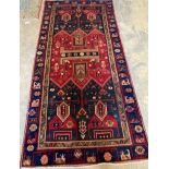 A Caucasian design blue ground geometric rug, 140 x 300cm