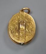 A Victorian engraved yellow metal oval locket , with belt and buckle motif, 26mm, gross 10.4