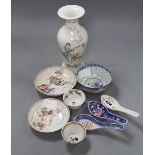 Two 18th century Chinese famille rose tea bowls and two saucers, together with three rice spoons and