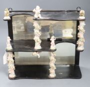 A decorative ceramic and wooden and mirrored wall shelf, height 35cm width 35cm