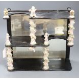 A decorative ceramic and wooden and mirrored wall shelf, height 35cm width 35cm