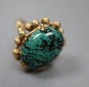 A continental yellow metal and malachite? set dress ring, size N, gross 8.7 grams.