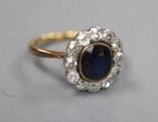 A 1940's/1950's? yellow metal, sapphire and diamond set oval cluster ring, size I/J, gross 3 grams.