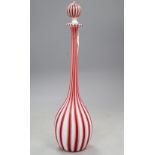 A slender Venetian red and white glass bottle and stopper