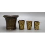 A 19th century bronze mortar and three small Persian measures