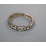A white metal and diamond set full eternity ring, size N/O, gross 2.8 grams.CONDITION: Four of the