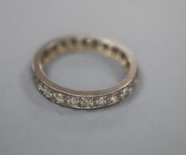 A white metal and diamond set full eternity ring, size N/O, gross 2.8 grams.CONDITION: Four of the