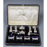 A George V cased ten piece silver condiment set, Adied Bros, Birmingham, 1925 and four associated