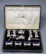 A George V cased ten piece silver condiment set, Adied Bros, Birmingham, 1925 and four associated