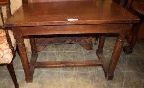 A walnut table, on gun barrel turned legs with H stretchers and block feet, 18th century and