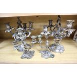 A pair of white metal candelabra and a pair of bronze two branch candelabra