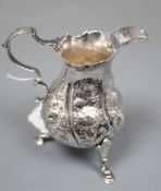 A late George II silver cream jug, with later embossed decoration, London, 1758, 10.1cm, 91 grams.