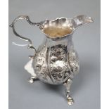 A late George II silver cream jug, with later embossed decoration, London, 1758, 10.1cm, 91 grams.