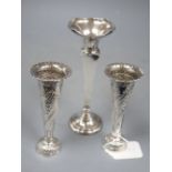 A pair of late Victorian embossed silver spill vases, 13.2cm and a larger silver vase, all