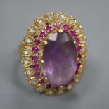 A yellow metal, amethyst, ruby and rose cut diamond set oval dress ring, with diamond set shoulders,