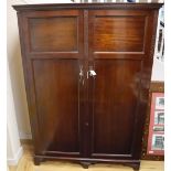 A 1920's mahogany compactum wardrobe, W.132cm, D.52cm, H.182cm