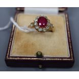 An early 20th century 18ct gold, synthetic? ruby and old round cut diamond set oval cluster ring,