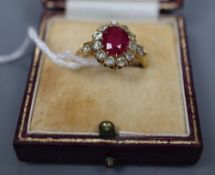 An early 20th century 18ct gold, synthetic? ruby and old round cut diamond set oval cluster ring,