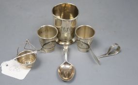 A pair of Russian (1927-1958) white metal and niello tots, a beaker, a strainer? and a spoon and