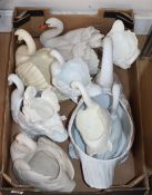 A collection of porcelain and pottery models of swans