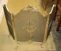 A Louis XV style gilt metal framed triple spark guard, W.110cm, H.80cm
