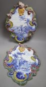 A pair of tinglaze blue and white cartouche shaped wall plaques, 19th century, each with