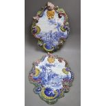 A pair of tinglaze blue and white cartouche shaped wall plaques, 19th century, each with