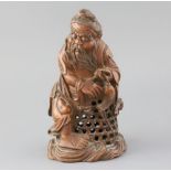 A Chinese bamboo figure of a fisherman, late 19th/early 20th century, the old man holding a fish