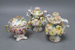 A pair of Minton or Coalport two handled floral encrusted pot pourri vases and covers and a floral