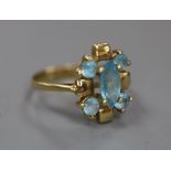 A modern 585 and blue topaz cluster dress ring, size J/K, gross 2.8 grams.