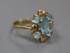 A modern 585 and blue topaz cluster dress ring, size J/K, gross 2.8 grams.