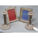 A pair of Edwardian silver candlesticks (a.f.), 17.3cm and two silver mounted photograph frames(a.