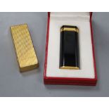 A boxed Cartier lighter and another unboxed
