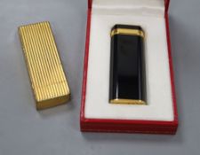 A boxed Cartier lighter and another unboxed