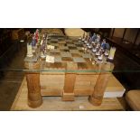 A Heritage Tables jigsaw chess table, modelled on Bodiam Castle with chequer glass top and a set