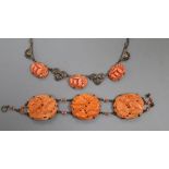 An early 20th century sterling and carved coral panel set bracelet, overall 17.3cm, decorated with