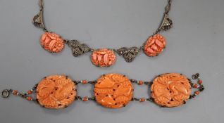 An early 20th century sterling and carved coral panel set bracelet, overall 17.3cm, decorated with